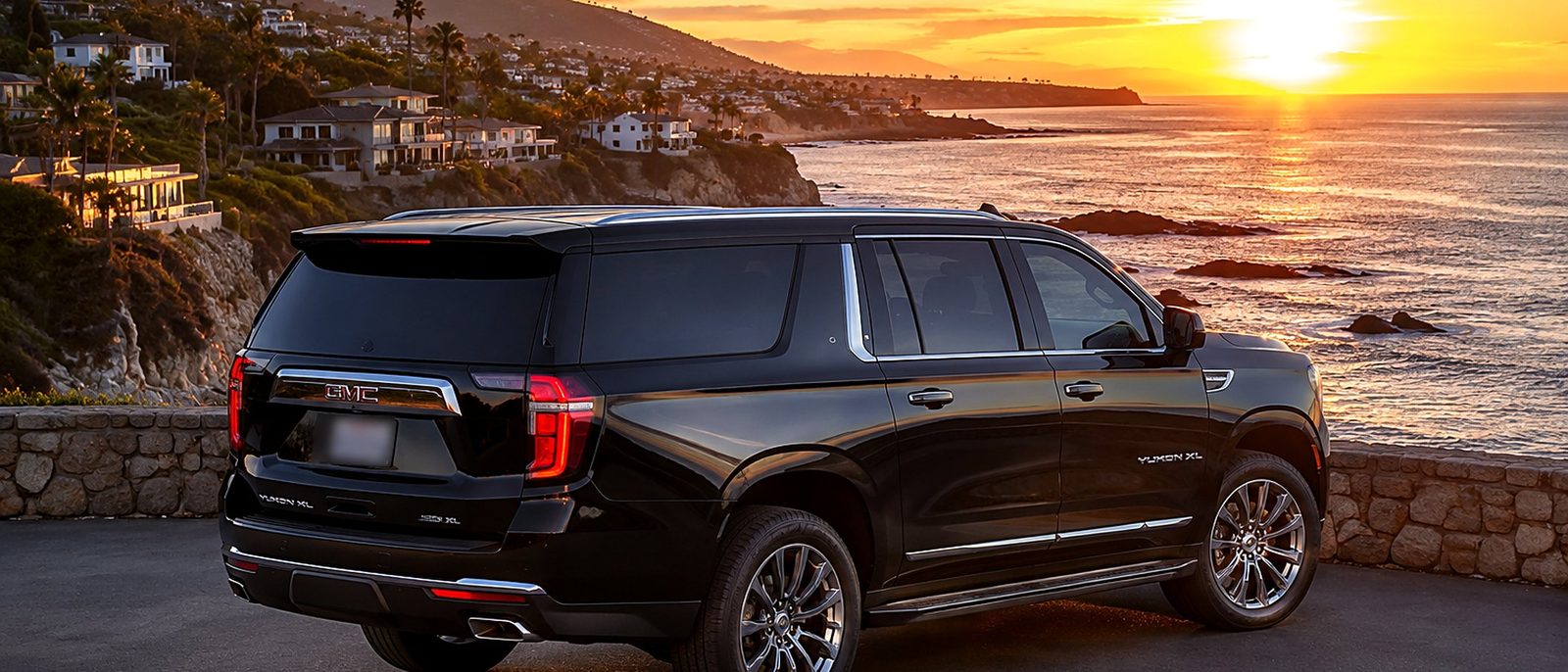Black SUV parked above the Pacific at sunset